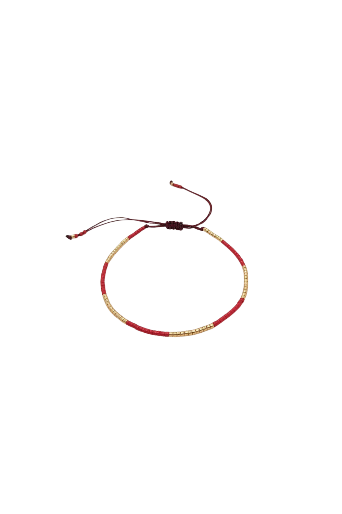 Bracelet with red and gold cord on a white background