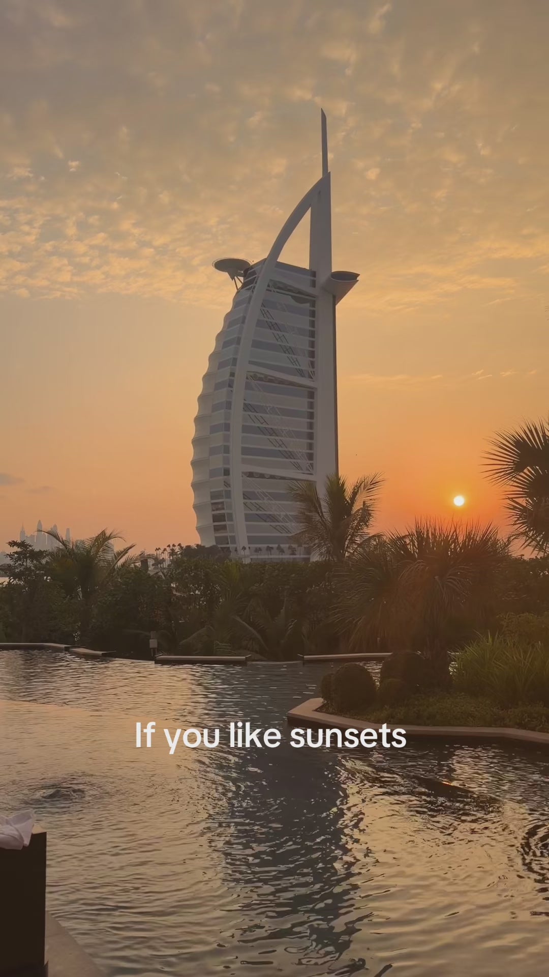 video of an iconic dubai landscape Jumeirah Burj Al Arab with a bikini that looks like a sunset