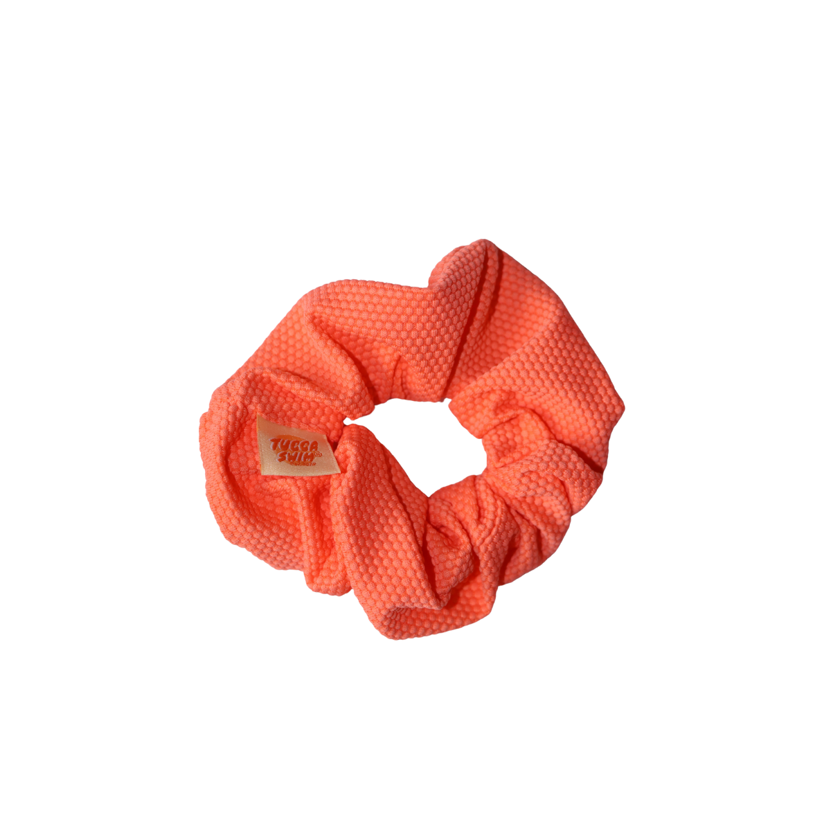 Coral scrunchie on a white background