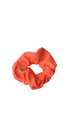 Coral scrunchie on a white background