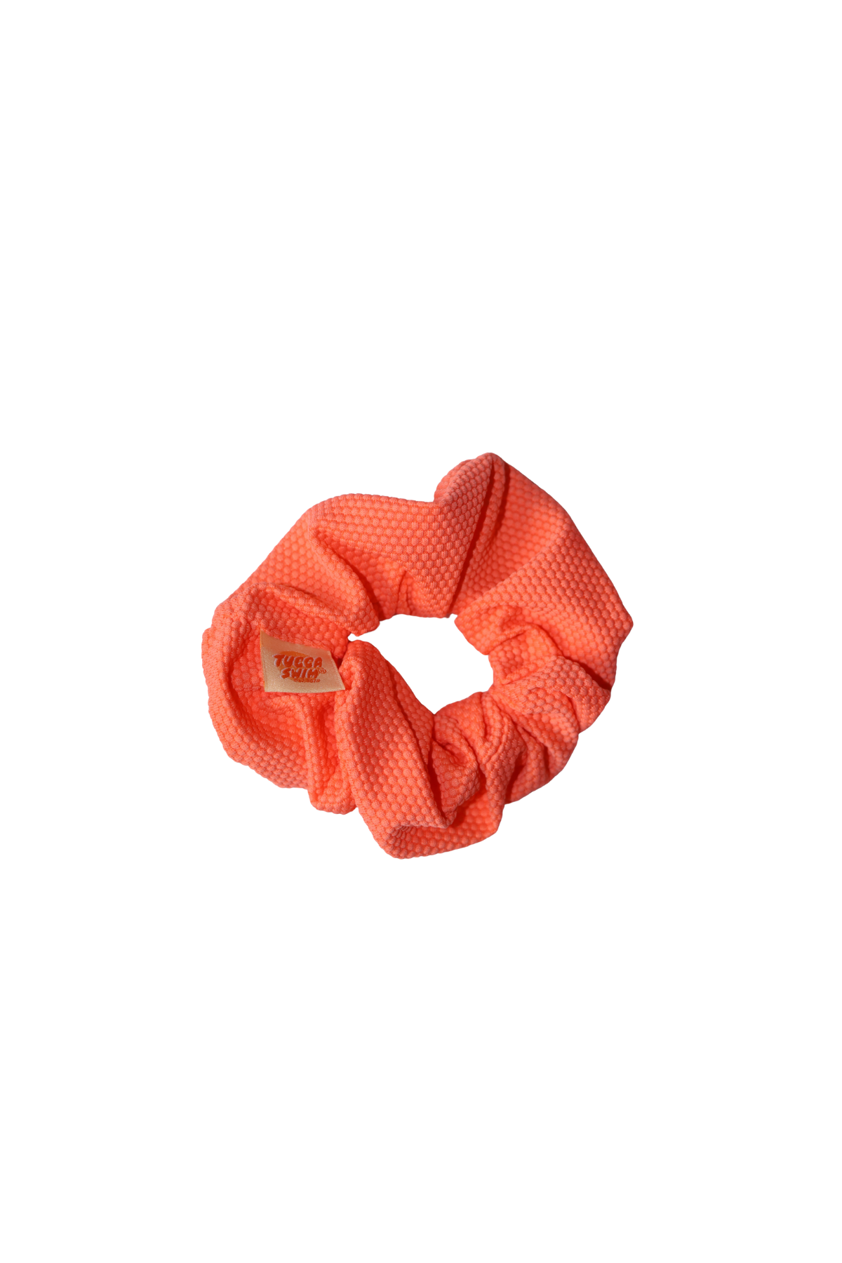 Coral scrunchie on a white background