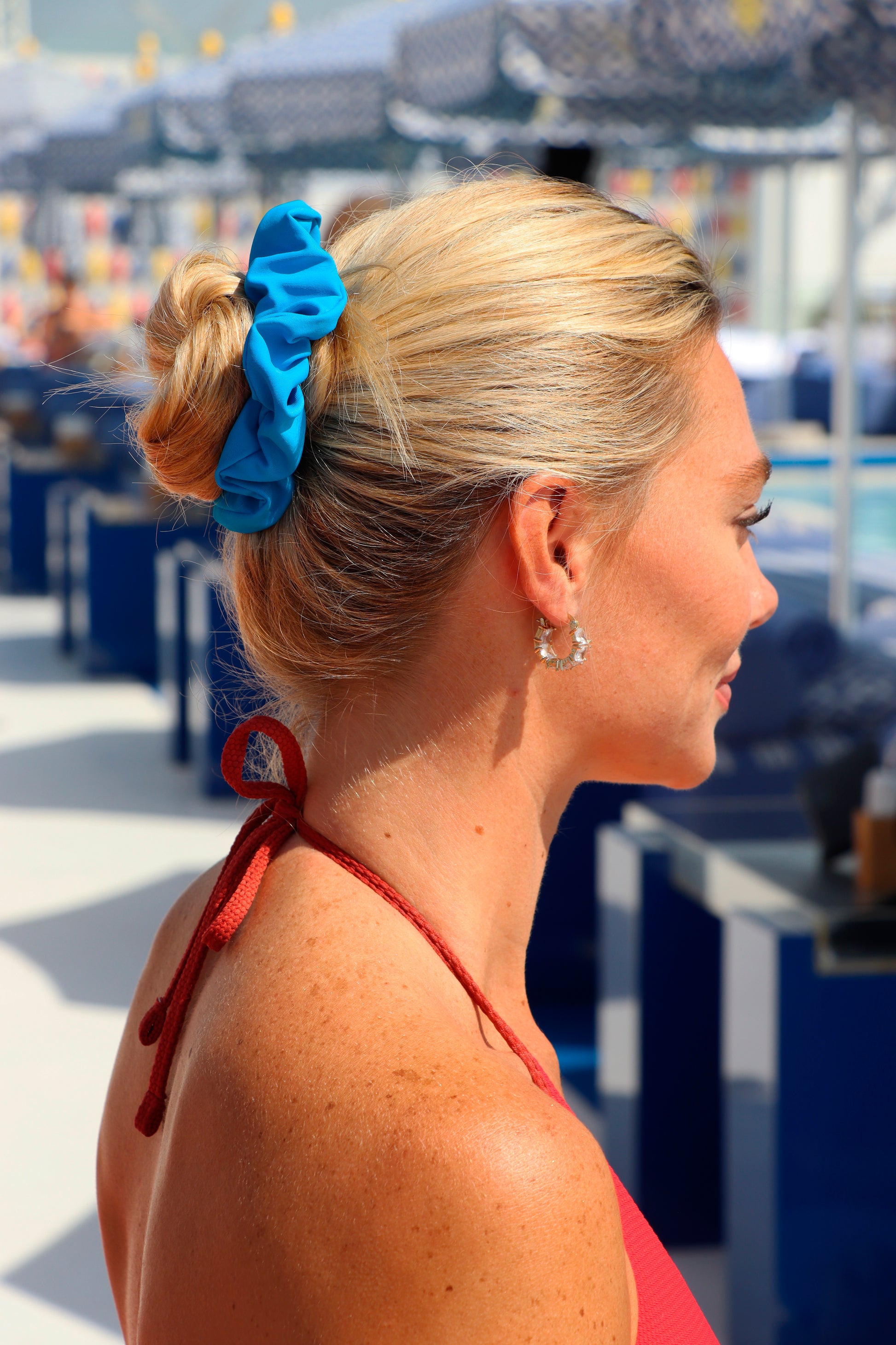 Woman with a blue scrunchie in her hair at an outdoor event