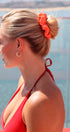 Woman with a bun wearing an orange scrunchie