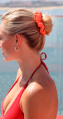 Woman with a bun wearing an orange scrunchie